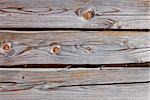 Old wooden logs as a part of wooden house walls