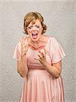 Single pregnant person in pink dress screaming