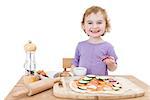 cute child making fresh pizza . studio shot isolated on white background