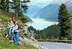 Summer view to Gepatsch-Stausee lake from alpine road and mother with children(Kaunertal, Austria, Tirol).