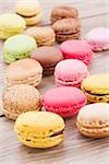 assorted french multicolored  macaroons on wooden table