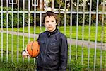 Portrait of serious boy street basket player