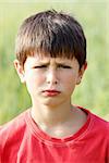 outdoor portrait of sad young teenager boy with shallow focus