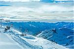 Morning winter windy mountain landscape with ski lift and cable cars. Ski resort Molltaler Gletscher, Carinthia, Austria.