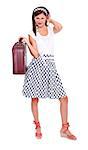 Brunette young woman in retro style dress holding a suitcase, looking to camera. Isolated.
