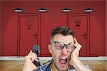 Composite image of portrait of frustrated computer engineer screaming while on call in front of open cpu over white background