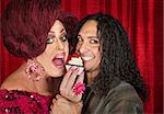 Drag queen with close friend eating cupcakes