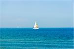 Seascape with sailboat the background of the blue sky.