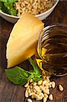 Italian basil pesto ingredients over old wood macro