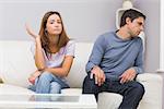 Unhappy couple not talking after argument at home on the couch