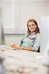 Smiling student studying in the computer room in college