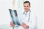 Portrait of a smiling male doctor with x-ray picture in the medical office