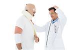 Side view of a doctor looking at patient tied up in bandage over  white background