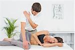 Male physiotherapist massaging woman's body in the medical office