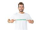 Portrait of a happy male volunteer pointing to himself over white background