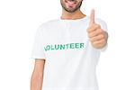 Closeup of a happy male volunteer gesturing thumbs up over white background