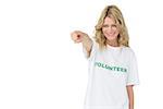 Portrait of a happy female volunteer pointing at you over white background