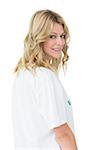 Portrait of a smiling young female volunteer standing over white background