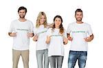 Group portrait of happy volunteers pointing to themselves over white background