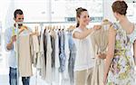 Female seller helping shopper choose the clothes in the store