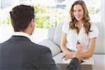 Smiling young woman in meeting with a financial adviser at home