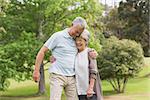 Happy senior man and woman embracing in the park