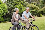 Side view of a senior couple on cycle ride in countryside