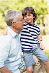 Portrait of a grandfather and son smiling in the park