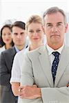 Business team standing in a line looking at camera in the office