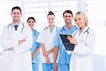 Portrait of confident happy group of doctors standing at the medical office