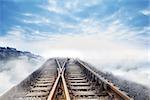 Railway tracks leading to clouds