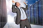 Businessman standing with arms pressing up against server hallway in the sky