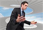 Businessman posing with arms out against spiral staircase in the sky