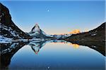 Matterhorn reflected in Lake Riffelsee at Sunrise with Moon, Zermatt, Alps, Valais, Switzerland