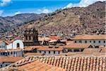 Overview of tile rooftops with mountains in the distance, Cusco, Peru