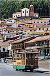 Trolley bus at Plaza de Armas and houses in background, Cusco, Peru