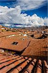 Overview of rooftops of homes with dramatic clouds, Cusco Peru