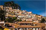 View of rooftops of homes and mountain, Cusco, Peru