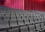 Grey chairs in empty auditorium