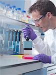 Male researcher using multi pipette in lab