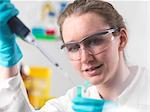 Laboratory worker pipetting sample into an eppendorf vial