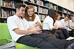 Row of teenagers hanging out in library