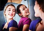 Young woman trying on dress, with friend