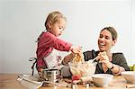 Mother and child mixing batter