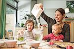 Mother and children baking in kitchen