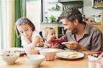 Father and children baking in kitchen