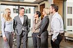 Businesspeople standing in conference room