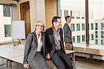 Businesspeople sitting on conference table