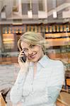 Businesswoman on telephone call, view through window