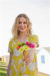 Portrait of young woman with flower cone, Whitstable, Kent, UK